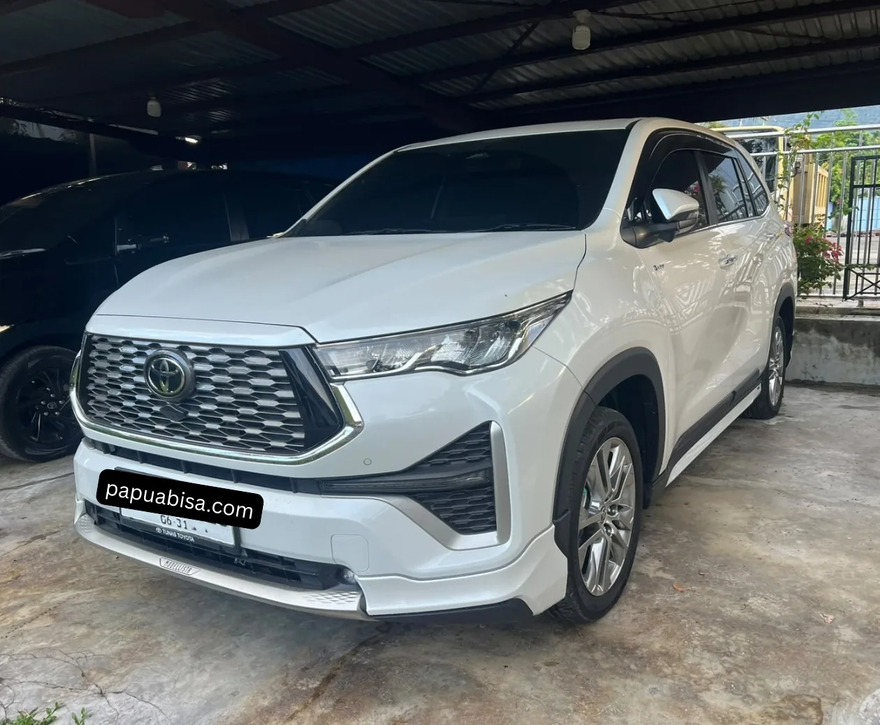 Unit Toyota putih di bawah carport